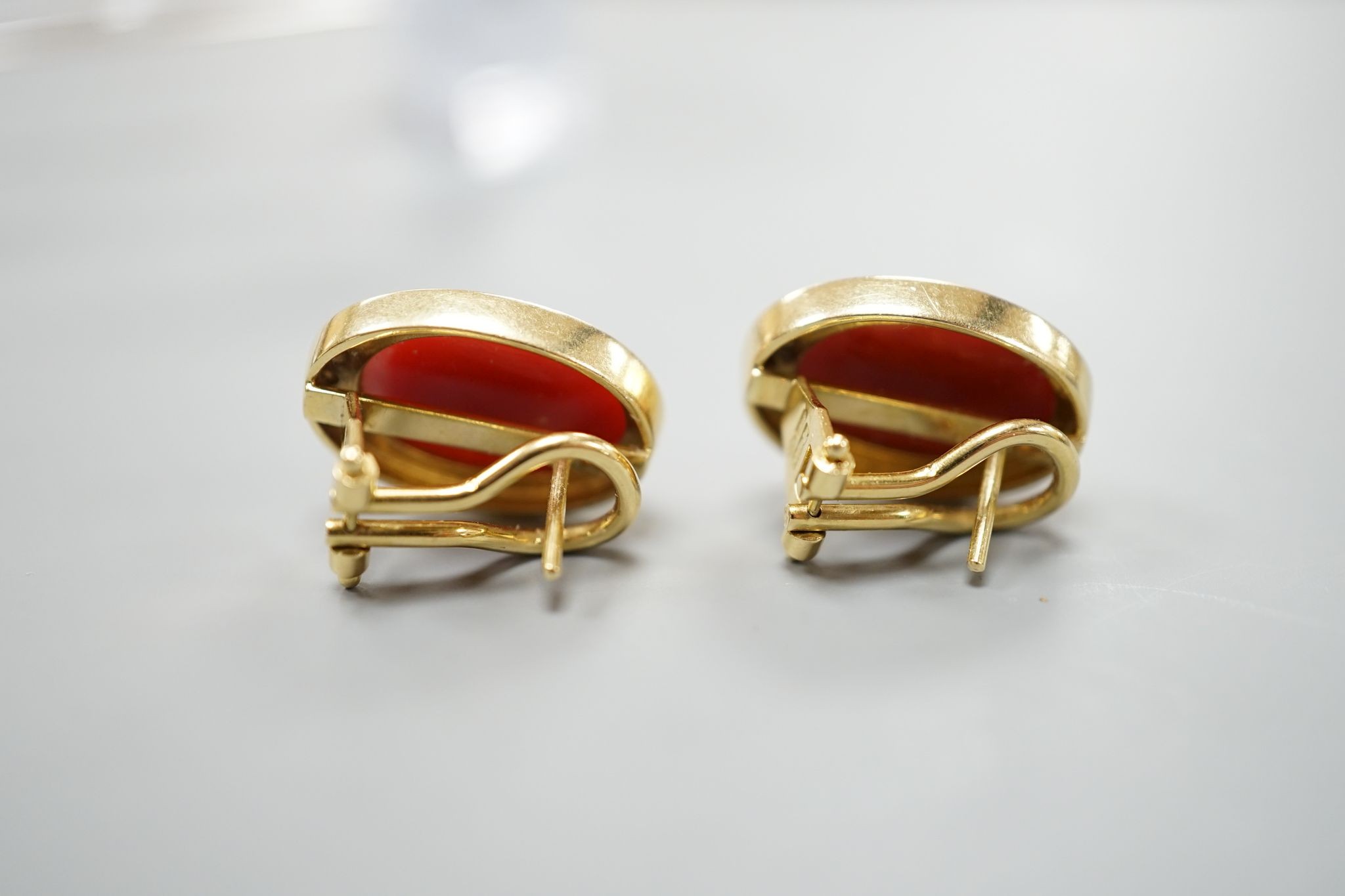 A pair of modern Italian 750 yellow metal a oval coral bead set earrings, 18mm, gross weight 11.7 grams.